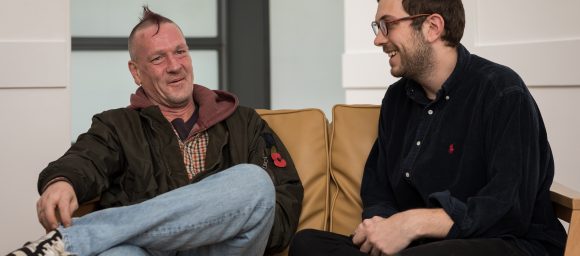 Staff member and customer chatting on the sofa