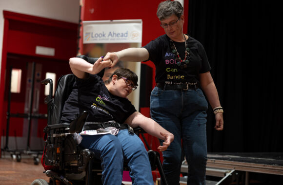 Two Look Ahead customers twirling each other round as part of their AnyBODY Can Dance performance.