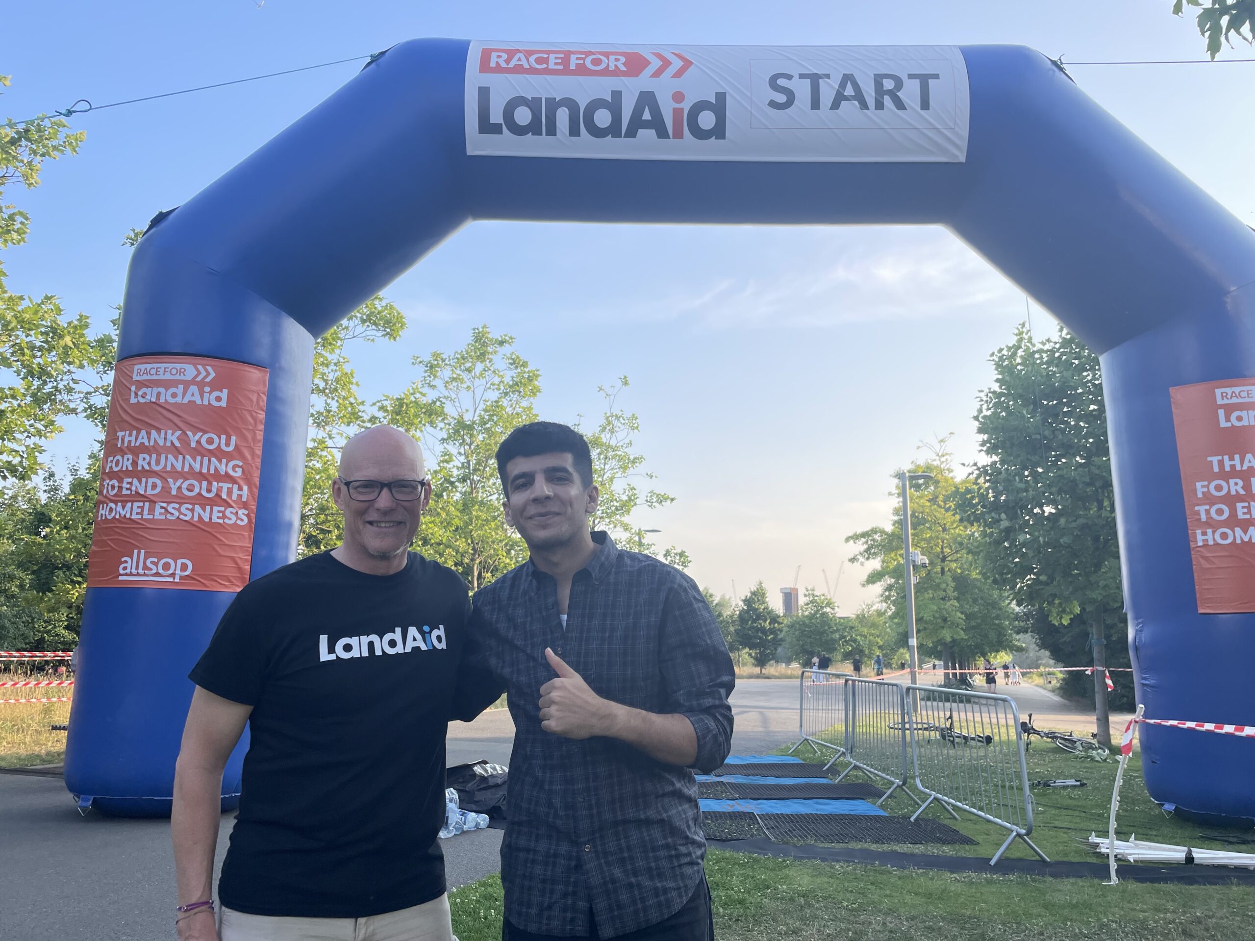 Look Ahead customer Omar and LandAid CEO Paul Morrish stand at the race start line.