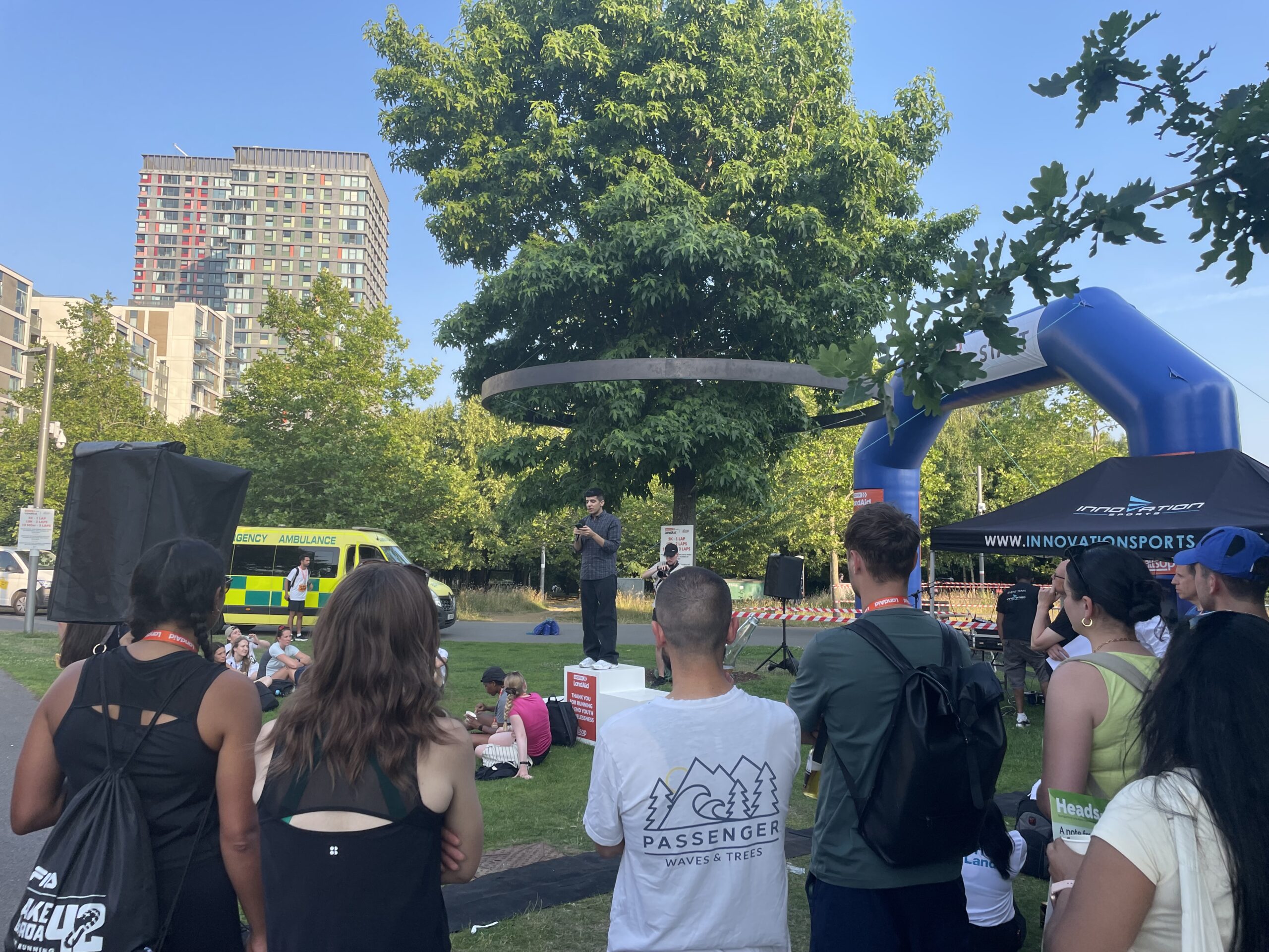 Look Ahead customer Omar speaks to a large audience while standing on a podium.