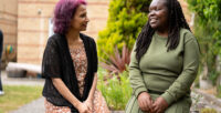 A Look Ahead customer and staff member chatting happily in the garden at a service.