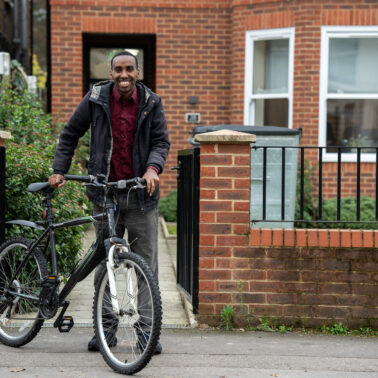 Customer looking happy and healthy with his bicycle.