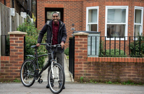 Customer looking happy and healthy with his bicycle.