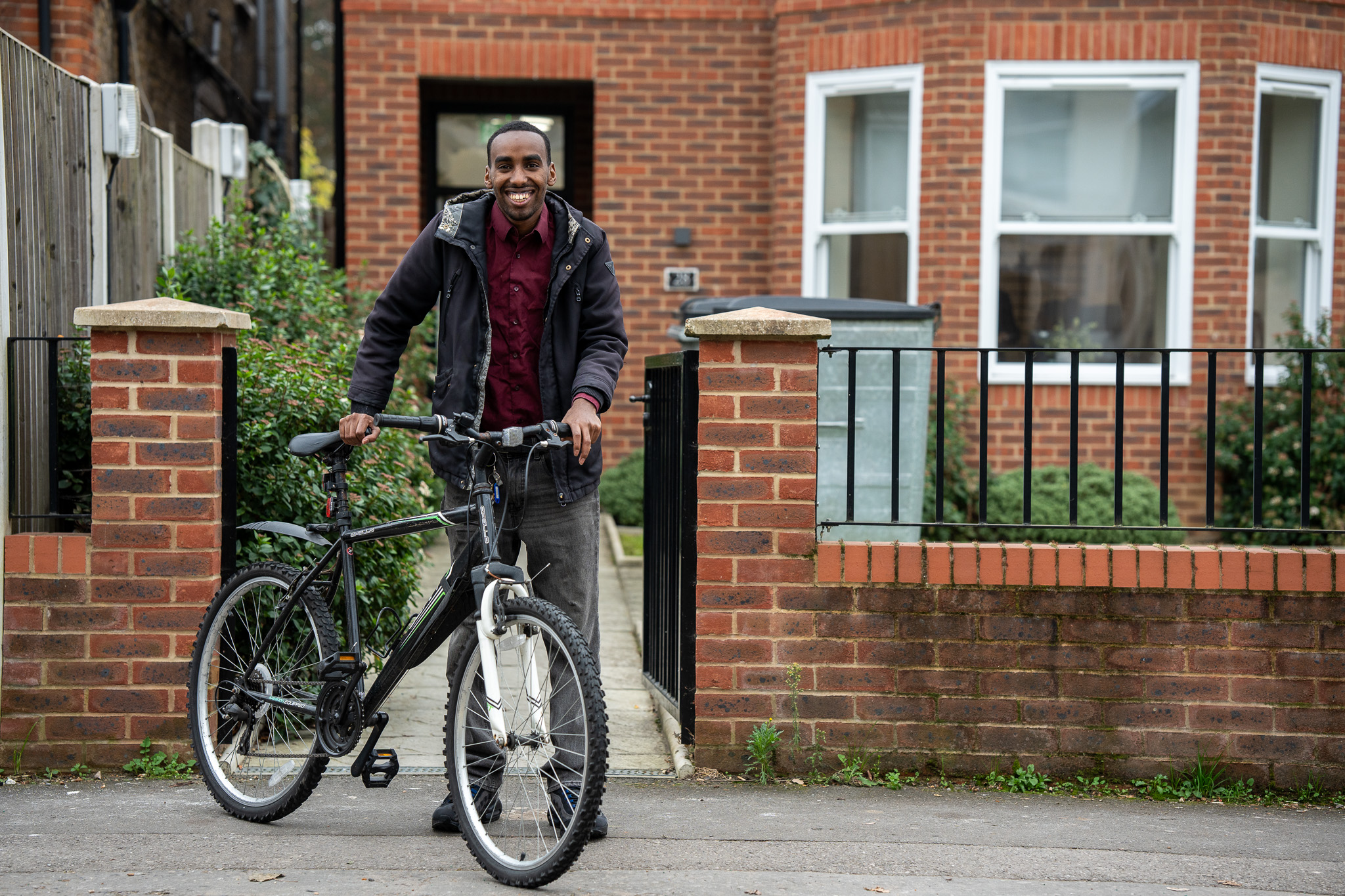 Customer looking happy and healthy with his bicycle.