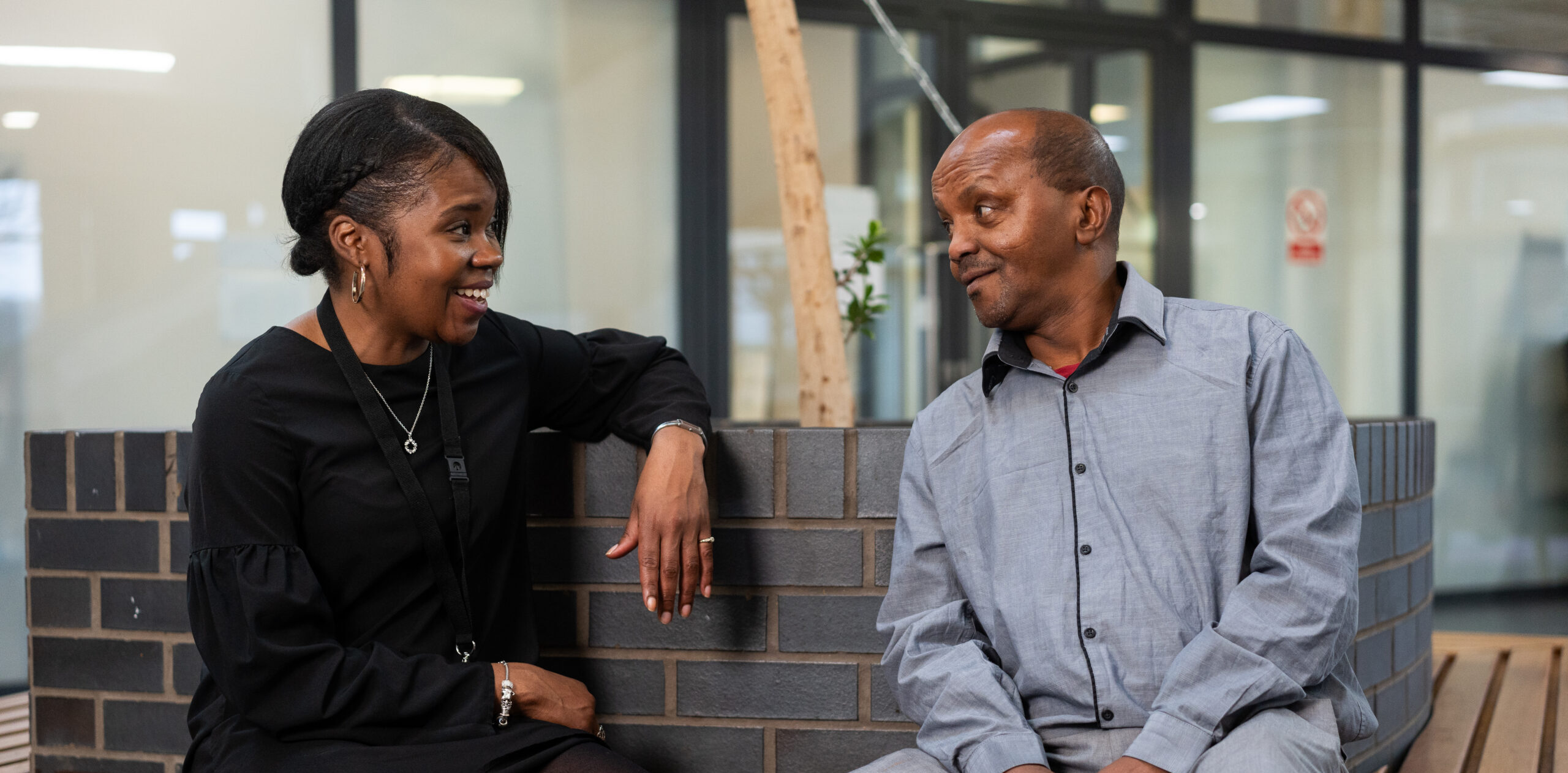A female support worker supporting a male client.