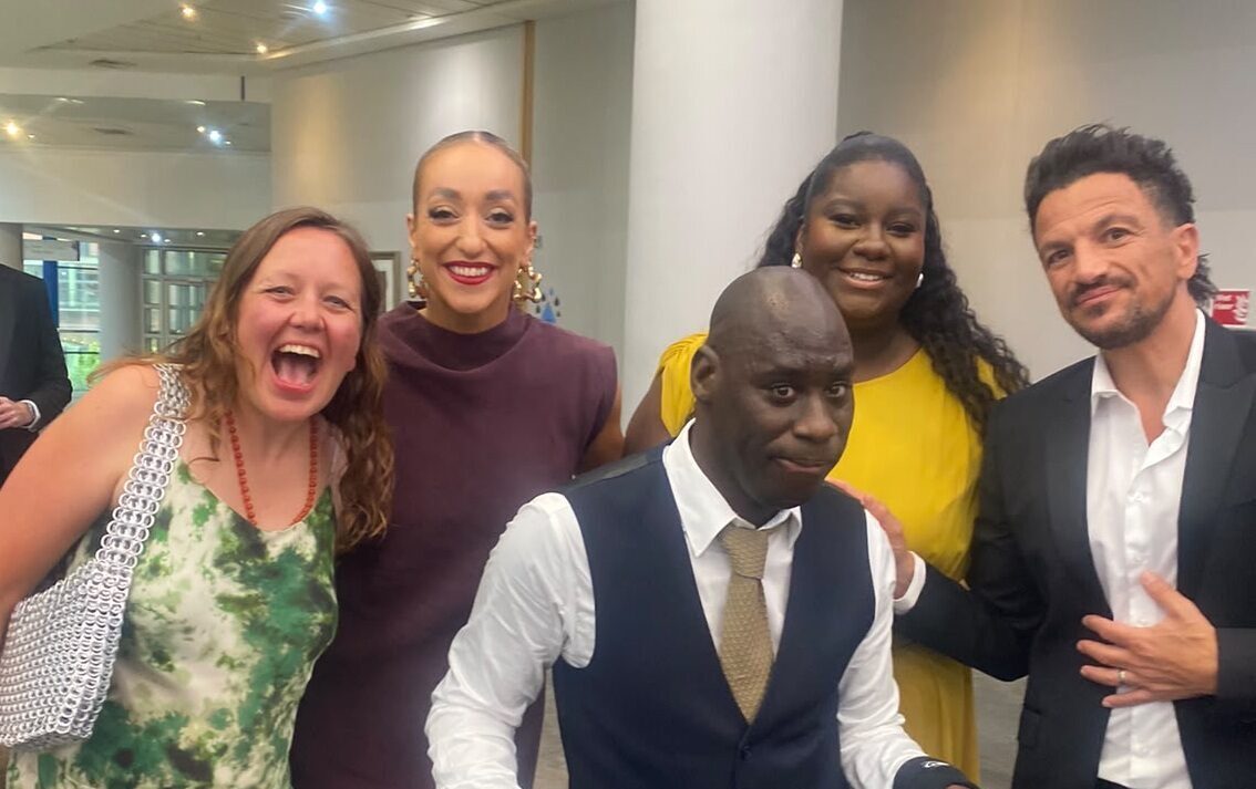 smartly dressed Look Ahead attendees pose for a photo with the host, singer-songwriter Peter Andre.